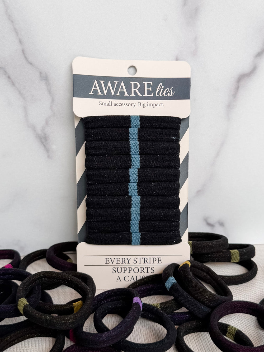 Pack of striped ties with a visible brand label on a textured background