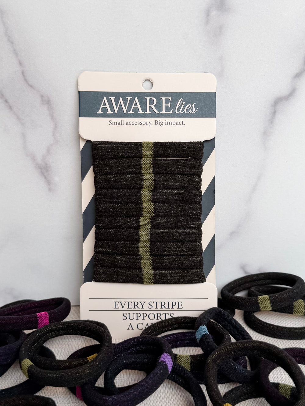Pack of black striped ties with a visible brand label on a textured background