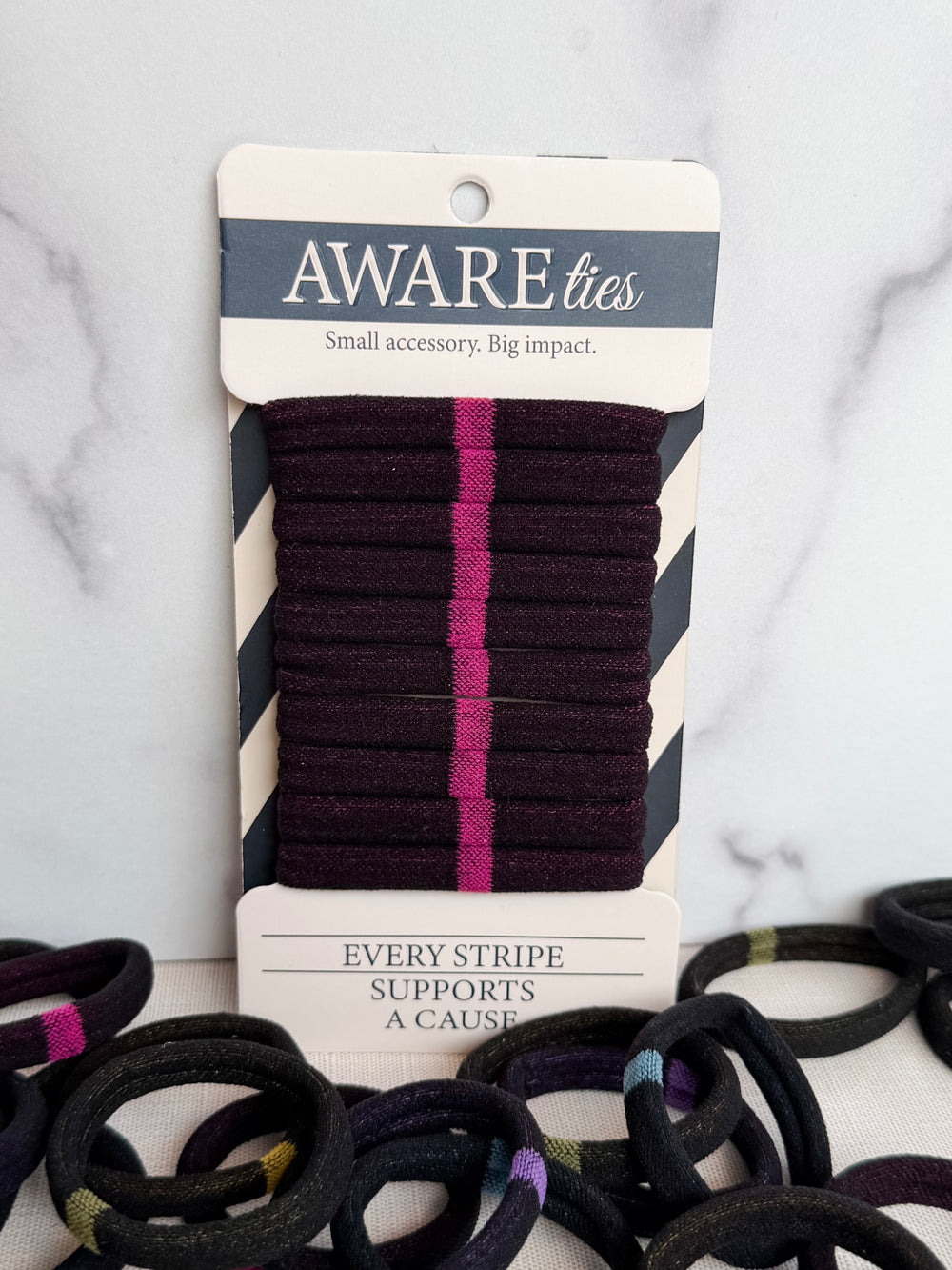 Pack of striped ties with a visible brand label on a textured background