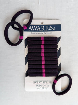 Black hair ties with pink stripes on a 'Aware' branded card against a white background