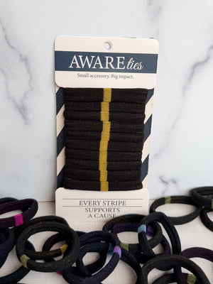 Packaged hair ties with visible branding on a marble background