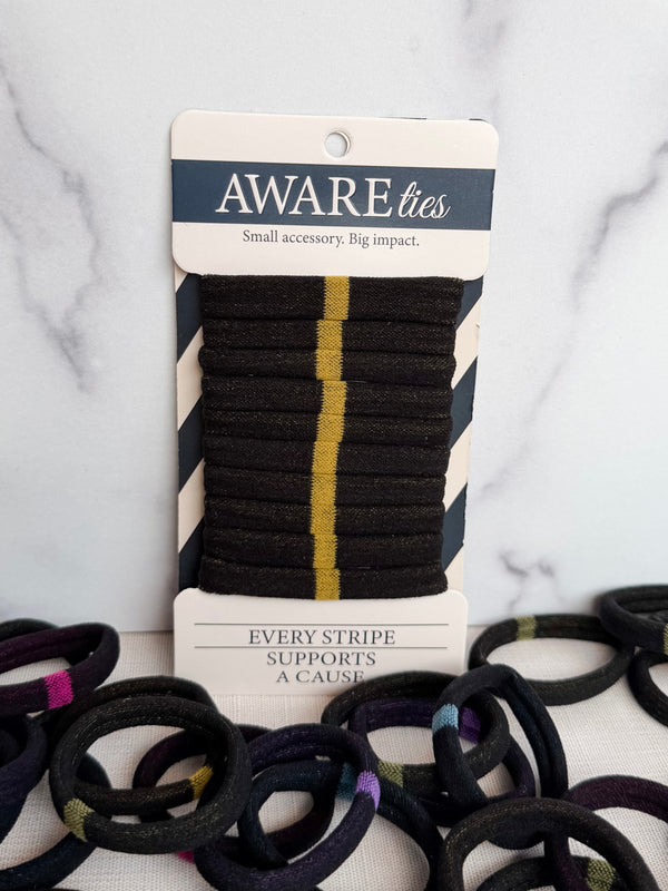 Packaged hair ties with visible branding on a marble background